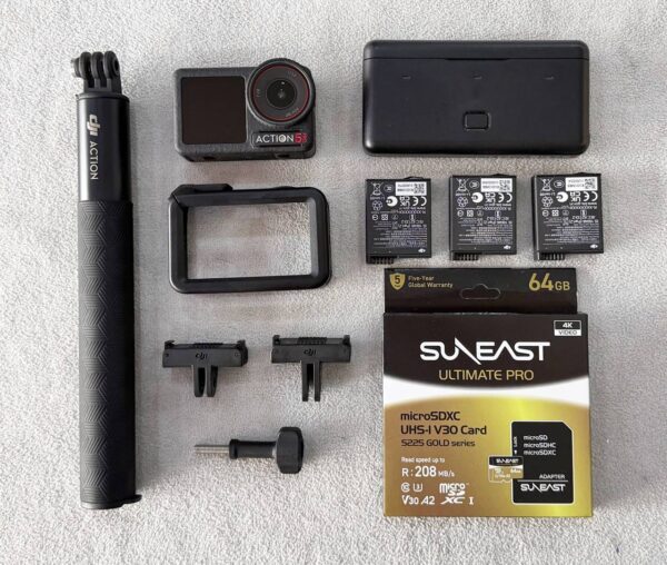 DJI Osmo Action 5 Pro action camera with dual OLED screens, wireless microphone, and Adventure Combo accessories – excellent condition